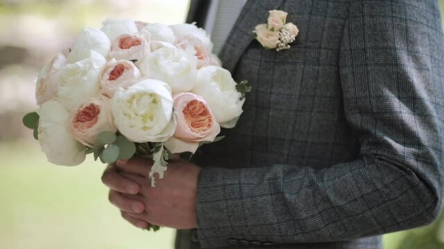 Wedding bouquet of white fresh peonies