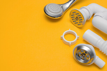 Shower siphon plastic parts on the yellow background with copy space.