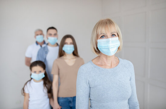Senior Woman In Face Mask Waiting In Line For Vaccine Against Coronavirus At Hospital, Empty Space