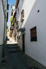 Jewish street in Granada, Spain, at noon with harsh light