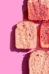 Toasts with strawberry jam on a pink background. Funny colorful food concept. Minimalist sandwich. Contemporary flat lay