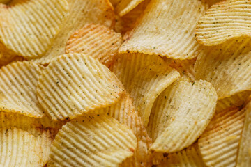 Potato chips or crisps .Potato chips texture background flat overhead view.concept of fast food and snacks. Food background.