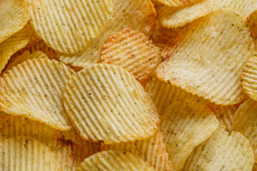 Potato chips or crisps .Potato chips texture background flat overhead view.concept of fast food and snacks. Food background.