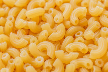 short Italian pipe pasta. Pasta is delicious Italian traditional food made from wheat flour like noodles.Dry pasta background.Top view