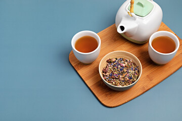 Traditional tea ceremony accessories, teapot and herbs and dry fruits tea. Destressing, relaxation, healing, healthy comforting, tea time, zen attitude concept. Top view