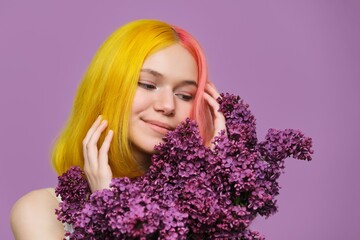 Teenager girl with dyed pink yellow hair with lilac flowers