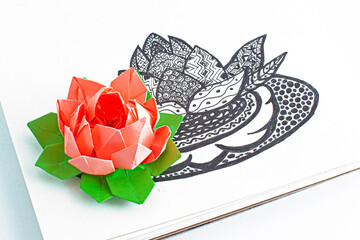 Origami lotus and lotus picture in graphics with ornaments