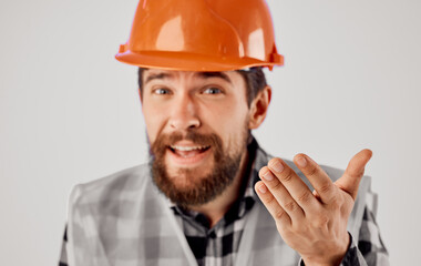 Cropped view of a civil engineer in a reflective vest and a scythe 
