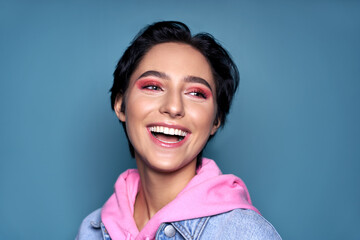 Happy teen girl face with dental healthy wide smile and trendy pink makeup laughing isolated on...