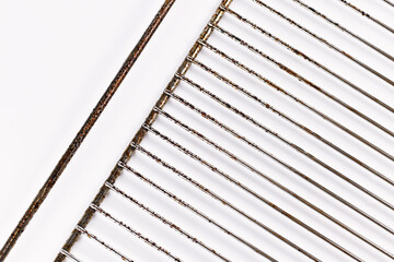 Dirty oven grill covered in burned fat on white background