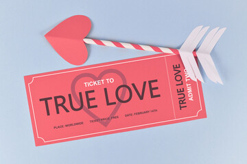 Cute Valentine's day concept with pink 'True Love' ticket and cupid arrow on blue background