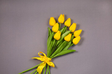 Bouquet of Yellow tulips over grey background