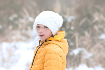 Young girl portrait in snow. Nature light portrait in winter.