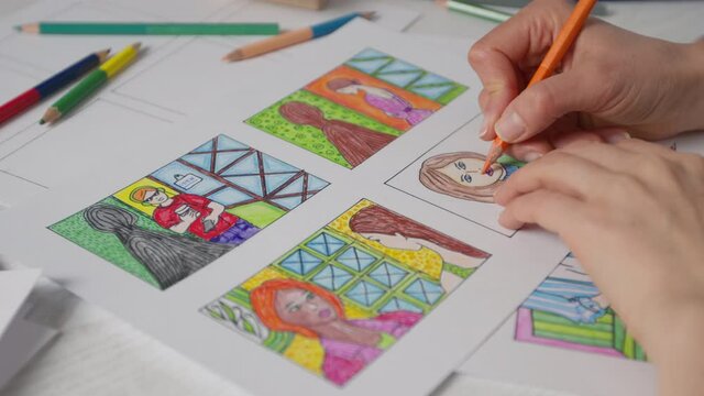 An illustrator artist draws a color storyboard on paper. Sketches for comics.