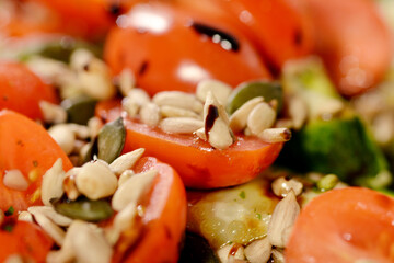 Mixed salad with tomato and cucumber and sunflower seeds