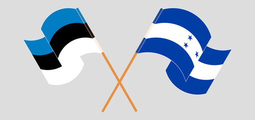 Crossed and waving flags of Estonia and Honduras