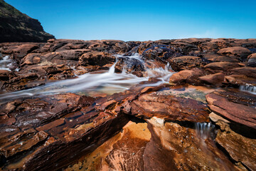 Fototapeta na wymiar Water on the rocks at Avoca Beach on NSW Central Coast