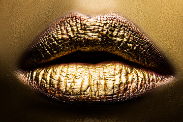 Closeup golden lips makeup. Make up ideas. Colorful bright lipstick gold art concept.
