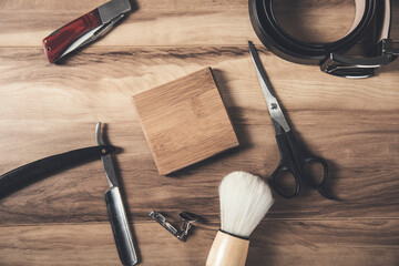shaving accessories and belt on table