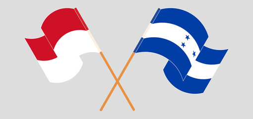 Crossed and waving flags of Honduras and Indonesia