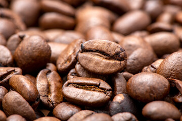Fresh coffee beans scattered as a background or texture.