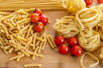 pasta and cherry tomatoes on bamboo board