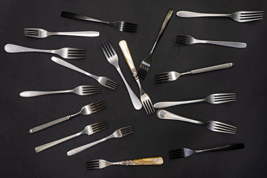 assorted forks on black background