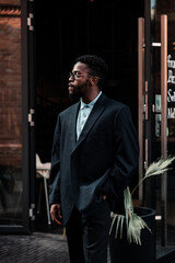  Fashion black man walking on street. Fashionable portrait of african american male model. Street style