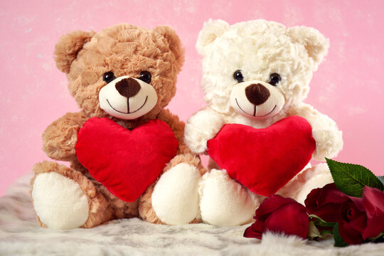 Happy Valentine's Day Teddy Bears With Love hearts gifts on pink and white fur background.
