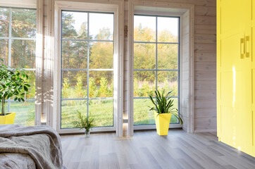 Bright interior, room in wooden house with large window. Scandinavian style. The trendy colors of...