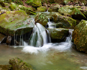 small waterfall running from a spring
