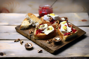 Bruschetta with brie cheese, jam, honey and nuts.