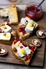 Bruschetta with brie cheese, jam, honey and nuts.