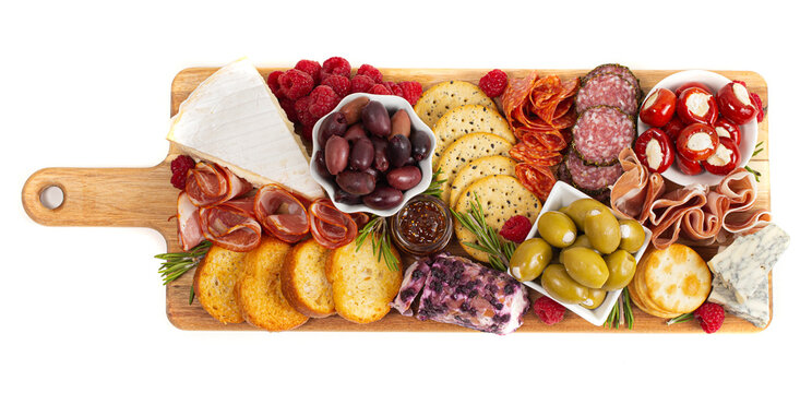 A Savoury Charcuterie Board Covered in Meats Olives Peppers Berries and Cheese