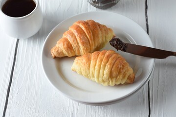 croissants and coffee served with chocolate for delicious breakfast