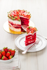 Red velvet cake on white wooden background. with strawberries