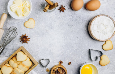 Fototapeta na wymiar Valentine's Day baking culinary background. Ingredients for cooking on wooden kitchen table, baking recipe for pastry. Heart shape cookies. Top view. Flat lay.