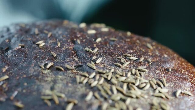 black rye bread sprinkled with caraway seeds close-up