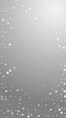 Random falling stars Christmas background. Subtle flying snow flakes and stars on grey background. Actual winter silver snowflake overlay template. Lively vertical illustration.