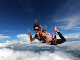 Young woman parachutist smiling in free fall. Perfect concept of happiness and freedom. - 404675973