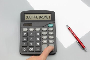 Person charged assets and money with calculator and gets indicated that he is broke