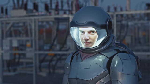 Futuristic worker. Solar farm. Portrait view of the smart cosmonaut examining power units while working on ecological green station at the evening. Our future, cosmic and technologies concept