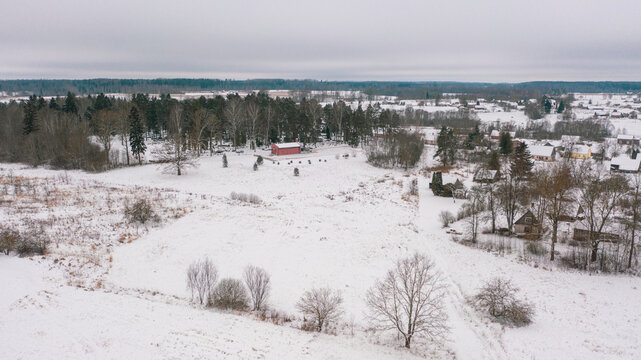 Akniste, Jekabpils, Latvia, Baltics.Beautiful panoramic aerial view photo from flying drone to Akniste city in winter.Beautiful winter view with snowy snow on small town fields and forests. (series)