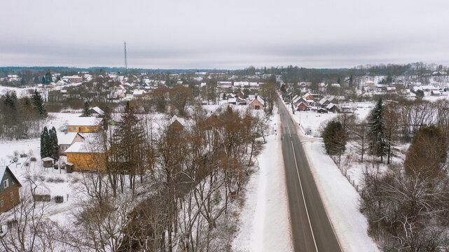 Akniste, Jekabpils, Latvia, Baltics.Beautiful panoramic aerial view photo from flying drone to Akniste city in winter.Beautiful winter view with snowy snow on small town fields and forests. (series)