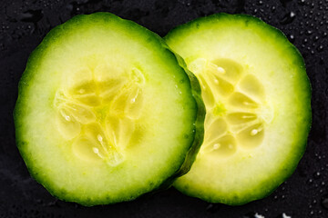 Cucumber slices isolated on closup details. Moisturising concept