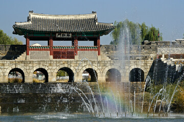 In Suwon, South Korea, a fountain at Hwaeseong Fortress makes a nice foreground for Hwahongmun, a tile-roofed water gate with stone arches on the Gwanggyo stream.