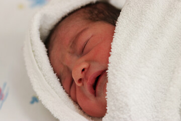Newborn child in a towel