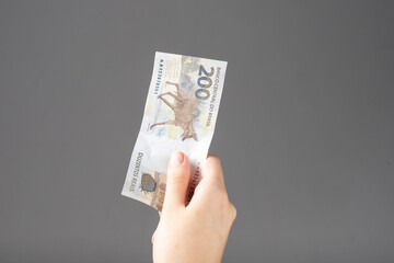 woman hand holding Brazilian money notes. Reais.