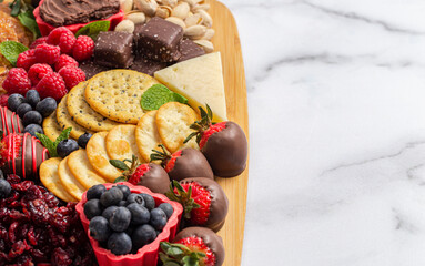 A Chocolate Covered Strawberries and Cheese Sweet Charcuterie Board on a Marble Counter