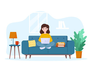 A woman works from home on the couch. Work from home concept. Freelance concept.